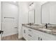 Bright bathroom with double vanity, granite countertop, and modern fixtures at 2704 Gaspar Ave, North Port, FL 34288