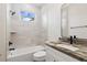 Bathroom featuring a shower and tub combination with stylish granite counters at 2704 Gaspar Ave, North Port, FL 34288