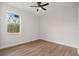 Bedroom featuring a window with a scenic outdoor view and wood-look flooring at 2704 Gaspar Ave, North Port, FL 34288