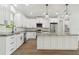 Modern kitchen with white cabinetry, stainless steel appliances, granite countertops, and a central island at 2704 Gaspar Ave, North Port, FL 34288