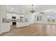 Bright, open-concept living space featuring a modern kitchen with an island and stylish pendant lighting at 2704 Gaspar Ave, North Port, FL 34288