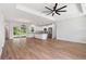 Spacious living area with modern kitchen, island, stainless appliances, and sliding glass door at 2704 Gaspar Ave, North Port, FL 34288
