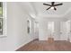 Airy main bedroom boasts a tray ceiling, wood floors, a window, and entryways to bath and closet at 2704 Gaspar Ave, North Port, FL 34288