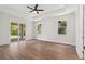 Bright, spacious main bedroom featuring a tray ceiling, wood-look flooring, and a sliding glass door to patio at 2704 Gaspar Ave, North Port, FL 34288