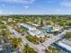 Aerial view of shopping and dining on Siesta Key, surrounded by lush tropical landscape and nearby homes at 302 And 304 Canal Rd, Sarasota, FL 34242