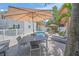 Outdoor entertaining space featuring a pool, dining area, grill, and lush tropical landscaping at 302 And 304 Canal Rd, Sarasota, FL 34242