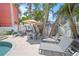 Private backyard featuring a patio, lounge chairs, outdoor dining set, and lush palm trees at 302 And 304 Canal Rd, Sarasota, FL 34242