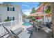 Backyard with a pool, patio, outdoor dining, and lounge chairs at 302 And 304 Canal Rd, Sarasota, FL 34242
