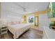 Comfortable bedroom with natural light, wood-look floors and ceiling fan at 302 And 304 Canal Rd, Sarasota, FL 34242