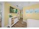 Bright bedroom with wood floors, a modern console, and coastal-themed decor at 302 And 304 Canal Rd, Sarasota, FL 34242