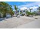 Inviting two-story beach house with palm trees and white gravel landscaping at 302 And 304 Canal Rd, Sarasota, FL 34242