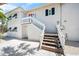 Two-story exterior featuring a private staircase leading to a second-story entrance at 302 And 304 Canal Rd, Sarasota, FL 34242