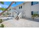 Two-story exterior featuring a private staircase leading to a second-story entrance at 302 And 304 Canal Rd, Sarasota, FL 34242
