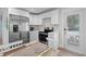 Modern kitchen with stainless steel appliances, white cabinets, and decorative backsplash at 302 And 304 Canal Rd, Sarasota, FL 34242