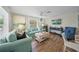 Comfortable living room featuring stylish furnishings, wood-look floors, and plenty of natural light at 302 And 304 Canal Rd, Sarasota, FL 34242