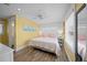 Bright main bedroom with wood floors, coastal-themed decor, and ensuite bathroom entrance at 302 And 304 Canal Rd, Sarasota, FL 34242