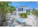 Backyard pool area with a lounging area, palm trees, and privacy fence at 302 And 304 Canal Rd, Sarasota, FL 34242