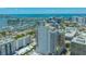 An aerial view showcases a luxury high rise condo with a marina, bridge and ocean in the background at 33 S Palm Ave # 1303, Sarasota, FL 34236