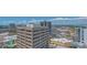 An aerial view showing a commercial building with surrounding buildings and city skyline on a partly sunny day at 33 S Palm Ave # 1303, Sarasota, FL 34236