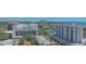 Aerial view showcasing a cityscape, buildings, green trees, and blue waters at 33 S Palm Ave # 1303, Sarasota, FL 34236
