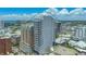 Aerial view of a modern high-rise condo building featuring many windows, balconies and a cityscape in the background at 33 S Palm Ave # 1303, Sarasota, FL 34236