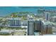 A stunning aerial shot showcases a high rise condo with a pool and marina, set against a backdrop of ocean and cityscape at 33 S Palm Ave # 1303, Sarasota, FL 34236