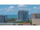 High-rise building view on a partly sunny day shows a residential area with blue skies at 33 S Palm Ave # 1303, Sarasota, FL 34236