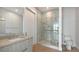 Modern bathroom featuring a glass-enclosed shower, sleek vanity, and neutral tones at 33 S Palm Ave # 1303, Sarasota, FL 34236