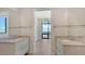 Elegant bathroom with double vanities and a view to bedroom and balcony at 33 S Palm Ave # 1303, Sarasota, FL 34236