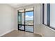 Bedroom with sliding glass door to balcony showcasing city views and natural light at 33 S Palm Ave # 1303, Sarasota, FL 34236