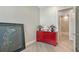 Bedroom view featuring a bright red dresser and a glimpse into the marble tiled bathroom at 33 S Palm Ave # 1303, Sarasota, FL 34236