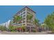 Beautiful exterior of a condo building with an architectural design and palm trees at 33 S Palm Ave # 1303, Sarasota, FL 34236
