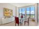 Elegant dining area with modern art, a glass table set and large windows with city views at 33 S Palm Ave # 1303, Sarasota, FL 34236