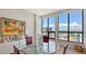 Bright dining area featuring hardwood floors, decorative art, and expansive windows offering city views at 33 S Palm Ave # 1303, Sarasota, FL 34236