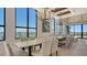 Elegant dining room with expansive windows offering city views, complemented by modern lighting and stylish decor at 33 S Palm Ave # 1303, Sarasota, FL 34236