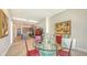 Elegant dining area with a glass-top table, red chairs, and a view of the open-concept kitchen at 33 S Palm Ave # 1303, Sarasota, FL 34236