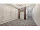 Hallway with gray carpet, elevator access, and wall mounted fire equipment at 33 S Palm Ave # 1303, Sarasota, FL 34236