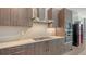 Contemporary kitchen featuring wood cabinets, modern appliances, and sleek countertops at 33 S Palm Ave # 1303, Sarasota, FL 34236