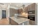 Stylish kitchen boasts stainless steel appliances, a spacious center island, and modern wood cabinetry at 33 S Palm Ave # 1303, Sarasota, FL 34236