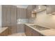 Modern kitchen with sleek wood cabinetry, stainless steel range hood, and cooktop at 33 S Palm Ave # 1303, Sarasota, FL 34236