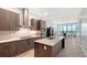Contemporary kitchen featuring sleek wood cabinetry, stainless steel appliances, and a spacious quartz island at 33 S Palm Ave # 1303, Sarasota, FL 34236