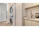 Modern laundry room featuring a stacked washer and dryer and utility sink with sleek countertops at 33 S Palm Ave # 1303, Sarasota, FL 34236