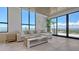Bright living room featuring floor-to-ceiling windows with city views and a comfortable seating area at 33 S Palm Ave # 1303, Sarasota, FL 34236