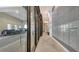 Hallway with wall-mounted mailboxes, modern gray wall and a glimpse of the parking garage through the glass wall at 33 S Palm Ave # 1303, Sarasota, FL 34236