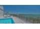 Rooftop pool and sun deck with lounge chairs and stunning ocean view in this luxury condo at 33 S Palm Ave # 1303, Sarasota, FL 34236