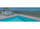 Picturesque rooftop pool with comfortable lounge chairs overlooking a stunning bay and cityscape at 33 S Palm Ave # 1303, Sarasota, FL 34236