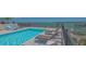 Stunning rooftop pool with comfortable lounge chairs and panoramic views of the bay and city skyline at 33 S Palm Ave # 1303, Sarasota, FL 34236