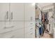 Spacious walk-in closet boasts custom shelving, drawers, and ample hanging space for organized storage at 33 S Palm Ave # 1303, Sarasota, FL 34236
