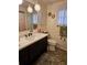 Traditional bathroom with updated vanity and decorative wall hangings at 3318 Oakwood S Blvd, Sarasota, FL 34237