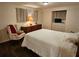 Bedroom with dark wood floors, a white bedspread, and a matching bedside chair at 3318 Oakwood S Blvd, Sarasota, FL 34237